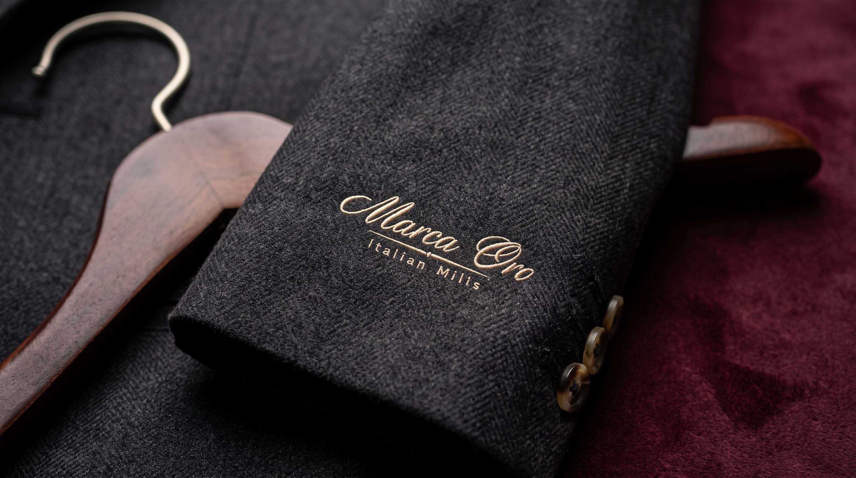 The Marca Oro signature embroidered on a jacket cuff