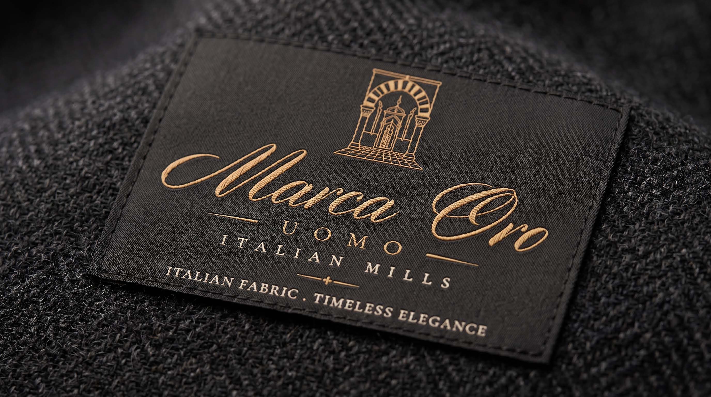 A woven Marca Oro label on textured dark cloth